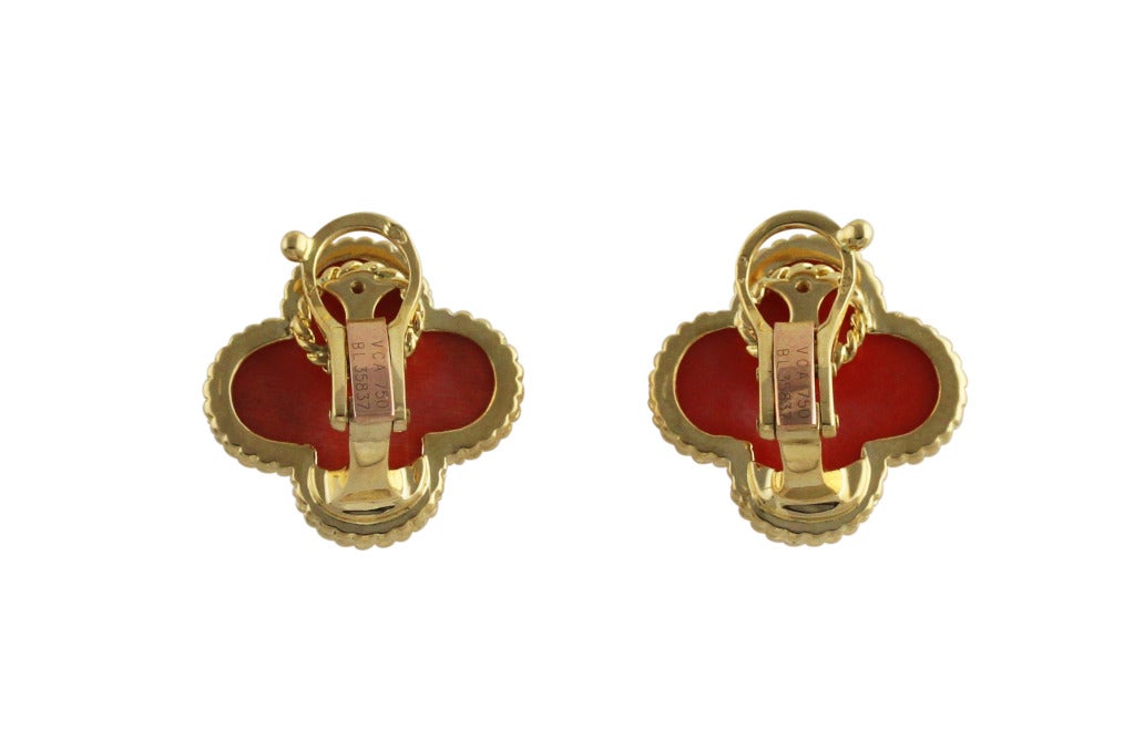 Pair of 18 karat yellow gold and coral 'Alhambra' Earclips, set in the center with carved coral segments with in gold frames, gross weight 11.2 grams, measuring 3/4 by 3/4 inch, signed VCA, numbered BL 35837, stamped 750, with French assay marks.
