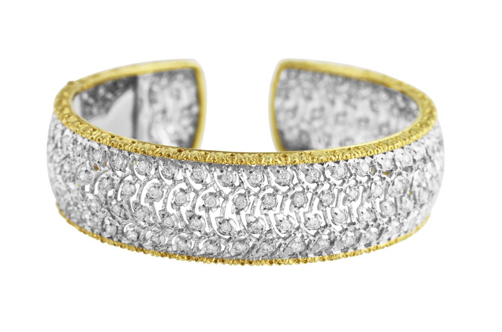 A beautiful 18 karat white and yellow gold and diamond cuff by Buccellati, of openwork tulle design set throughout with 152 round diamonds weighing approximately 5.00 carats, gross weight 46.4 grams, width 3/4 inch, signed M. Buccellati, Italy. 