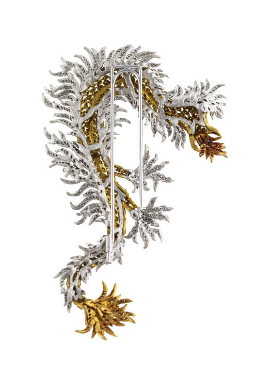 18 karat gold, diamond and ruby fire breathing dragon brooch by Buccellati, the slithering dragon of openwork design set throughout with 427 round yellow diamonds weighing 2.08 carats, the tendrils set with 448 round diamonds weighing 2.16 carats,