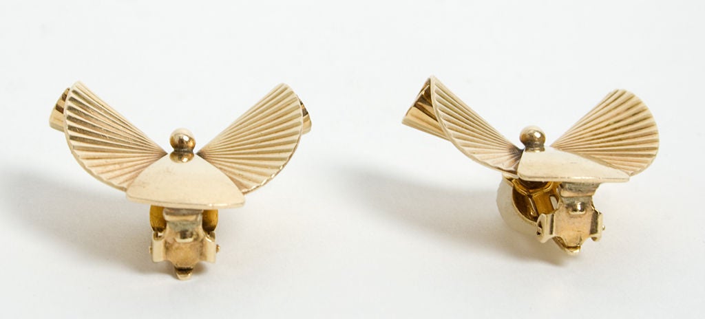 Fourteen karat gold earrings that are quintessentially Retro in design. Measure 1