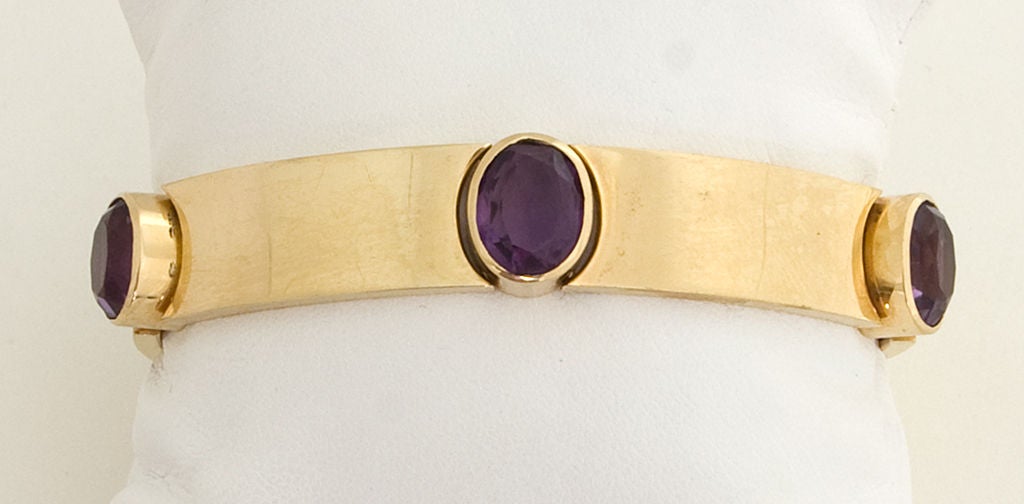 Unusual fourteen karat gold bracelet made of five links and five faceted amethysts. Bracelet measures 6 3/4