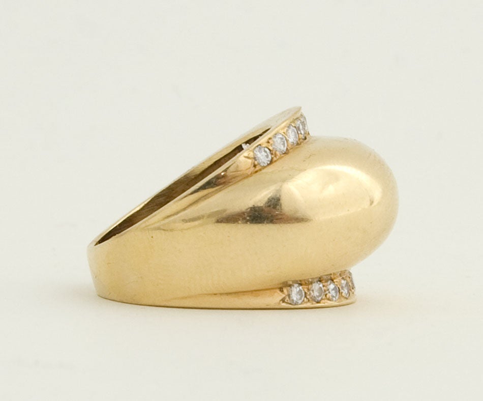 Strongly domed ring banded with diamonds. Fourteen karat gold; signed DPL. Currently size 8 1/2 but can be sized.