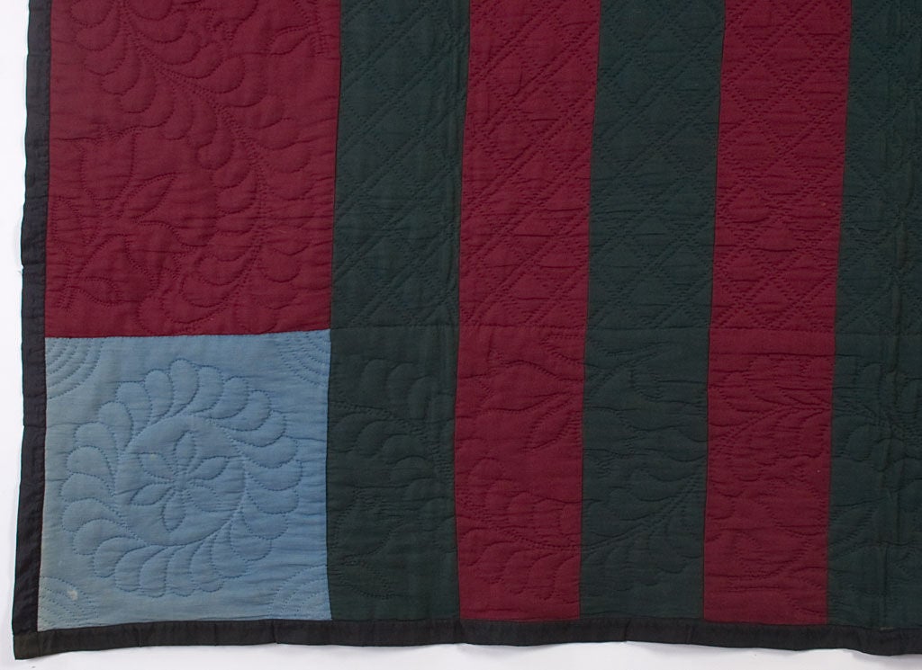 This Lancaster County Amish Bars Quilt is both classic and quirky. The absence of an inner border gives a very different look to what would otherwise be a very traditional pattern. The Bars are deep red and dark forest green. The Bars are quilted in