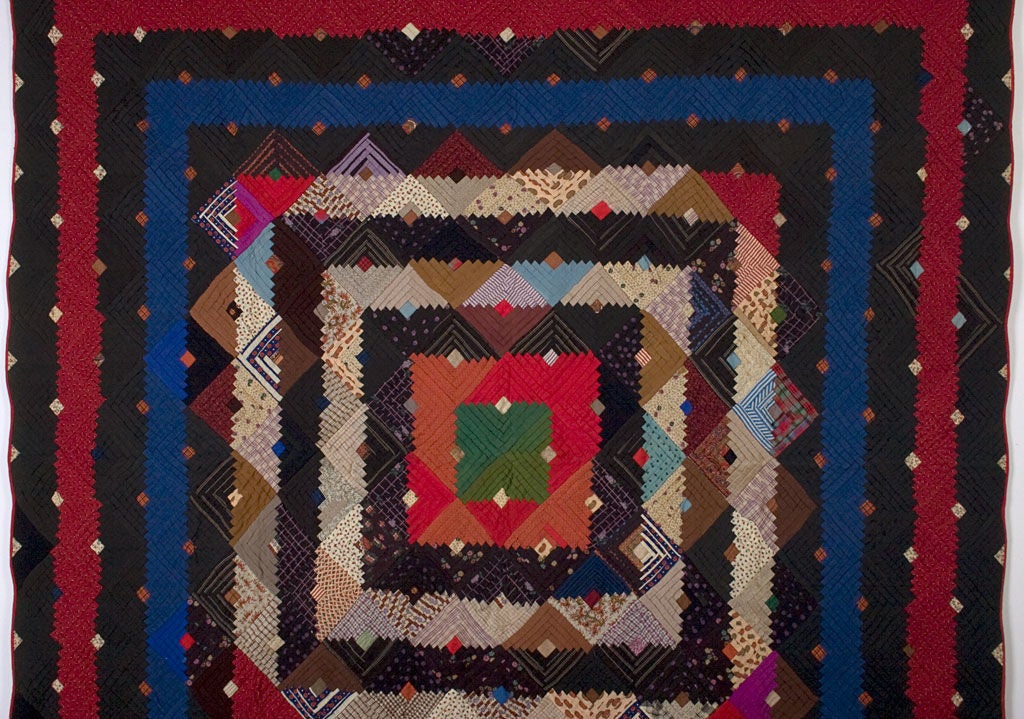 Richly colored Barnraising Log Cabin Quilt on Square done in beautiful wool challis fabrics. Solids and prints are well placed to make the various frames especially prominent. Excellent condition. Measures 78