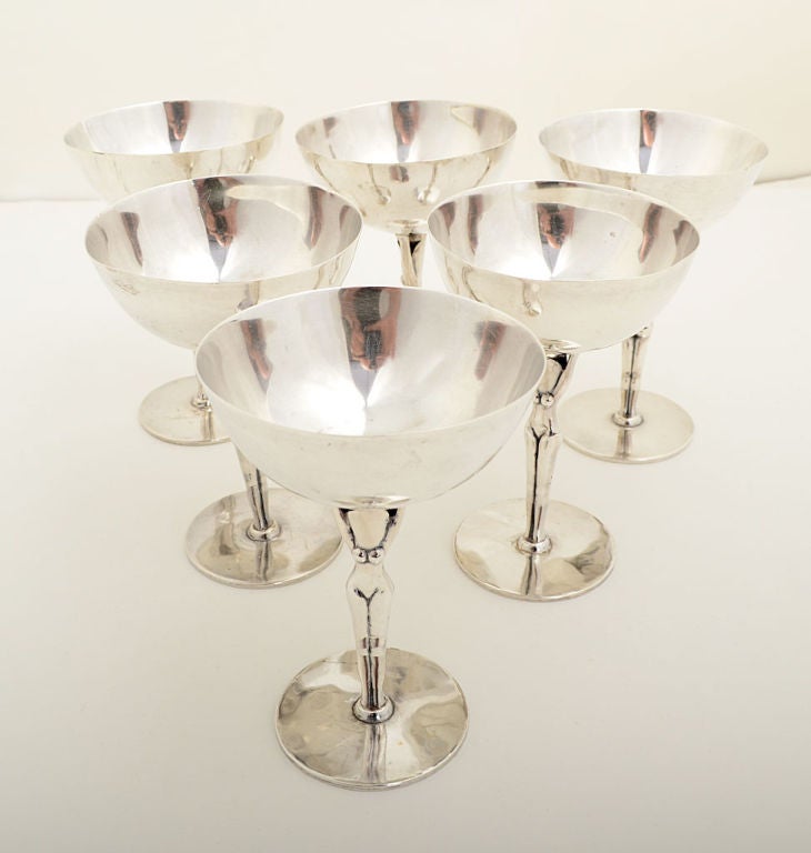 Unique set of six sterling goblets by Los Castillo gracefully depicting faceless nude women. What gentleman would not want to sip his drink while holding a naked woman in his hand? They are illustrated in 