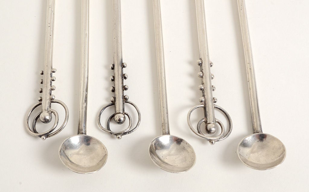 Set of six iced tea spoons by silver master, William Spratling. Intertwined circles at the ends  beautifully balance the serving part of the spoon. Measure 9