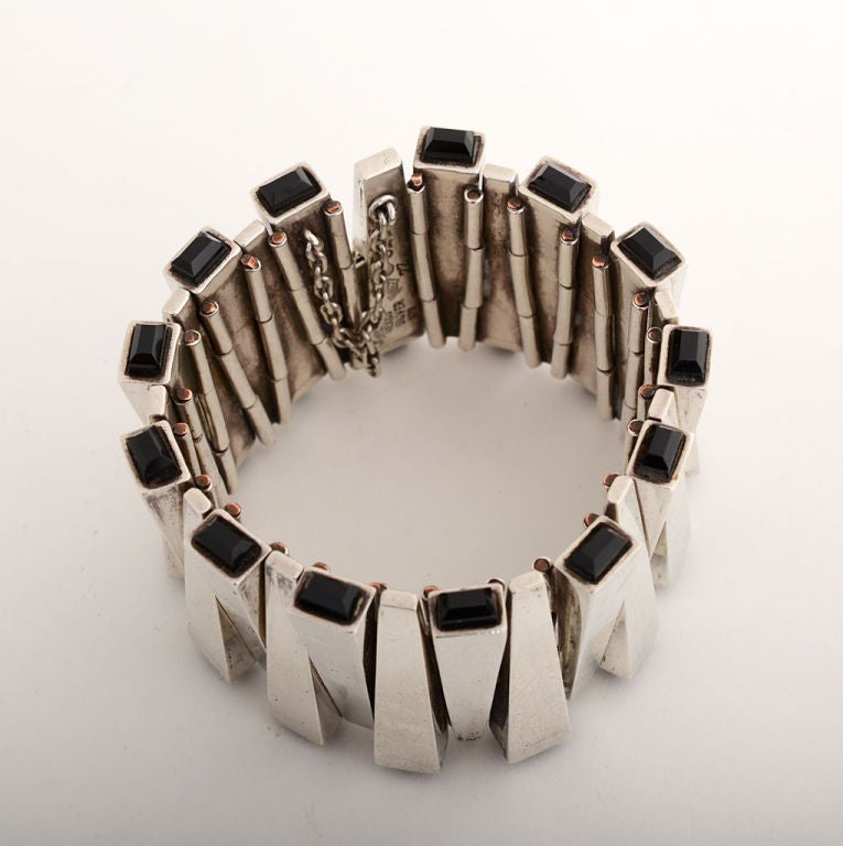 Dramatic, wide silver bracelet by Antonio Pineda. Alternating links each end in an onyx stone giving the appearance of matchsticks. This design illustrates the cover of the book 