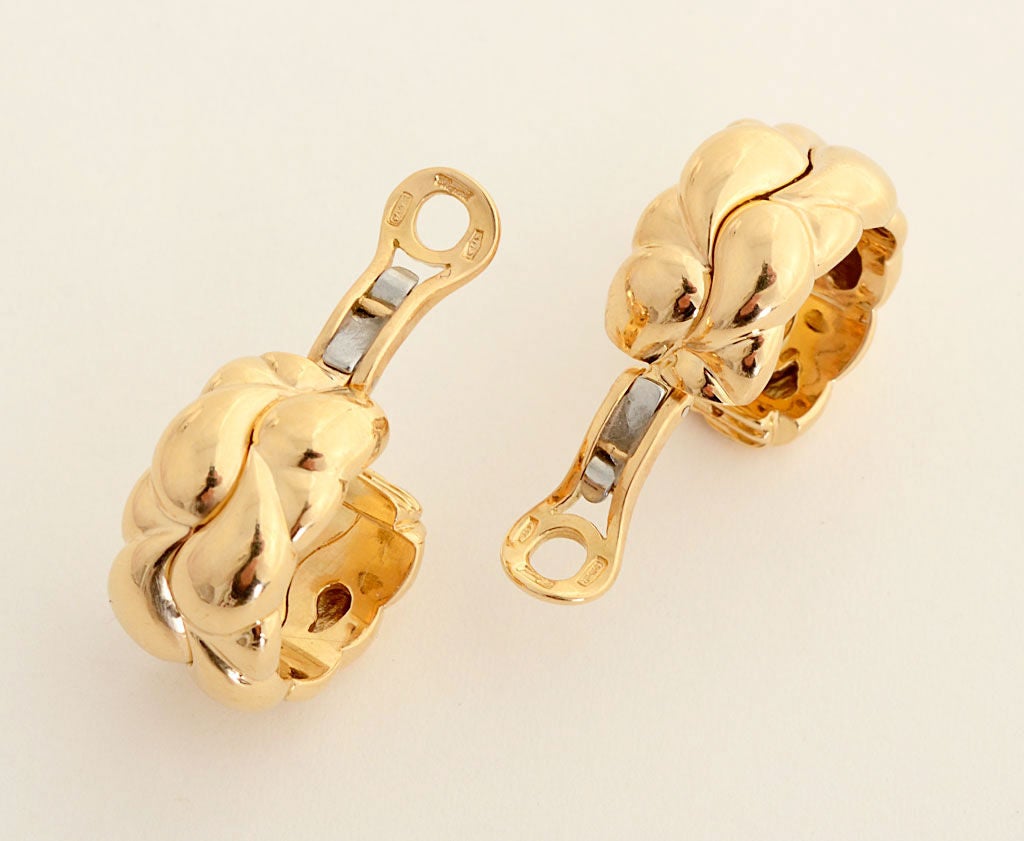 Eighteen karat gold earrings by Chopard from their Casmir Collection. These wonderfully sculptural hoops are perfect for any occasion. They measure 1 1/4