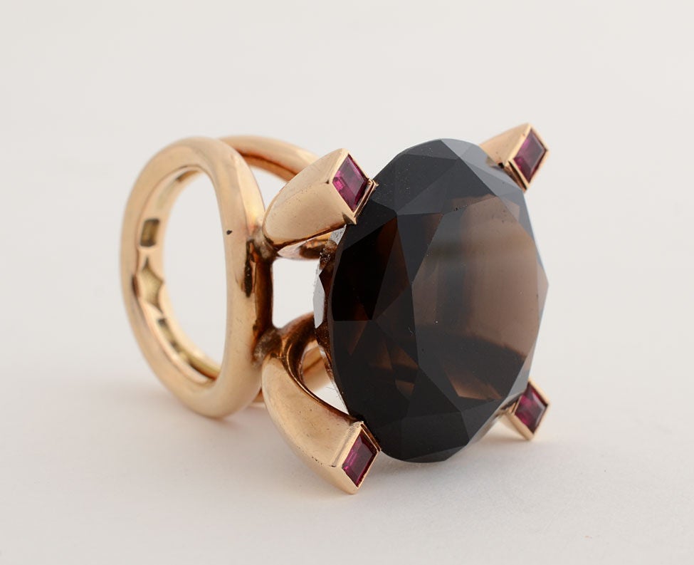 This custom made ring by Antonio Pineda is truly awesome. The central stone is a 43 carat smokey quartz surrounded by four natural rubies. Pineda is best known for his work in silver which is often quite architectural. He worked in gold for special