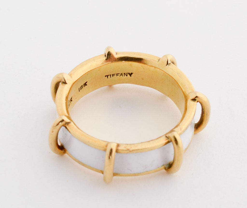Eighteen karat gold and enamel ring by Schlumberger for Tiffany.  White enamel is in excellent condition. Ring is size 6 1/2. Tiffany continues several enamel Schlumberger rings but I believe this model is no longer in production.