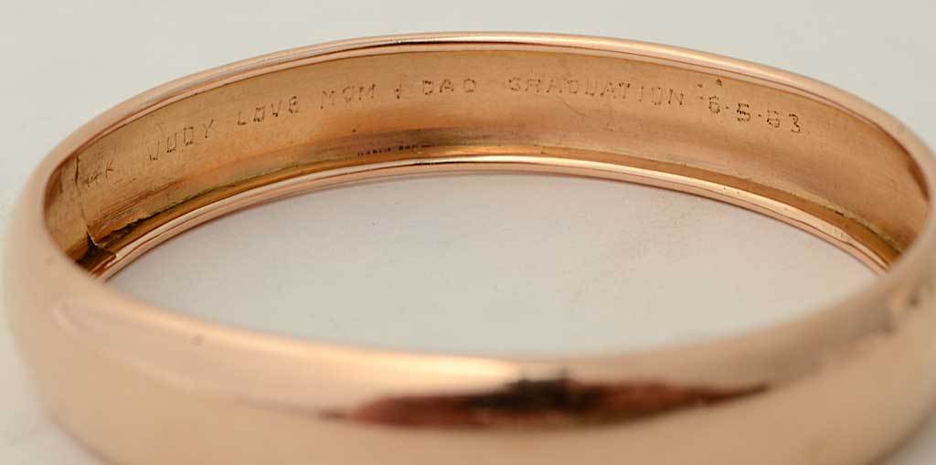 Heavy weight rose gold bangle bracelet in excellent condition. Inside is an inscription saying " Judy Love Mom and Dad Graduation 6-5-53". It is a slip on bracelet measuring 2 5/8 inside diameter X 2 5/16" interior height.