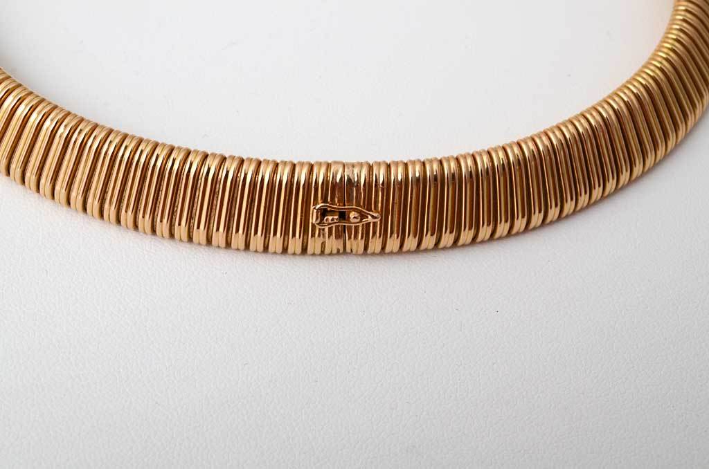 This classic Retro snake link necklace is unusual in two ways. It is wider than most and is 18 karat gold. It measures 1/2