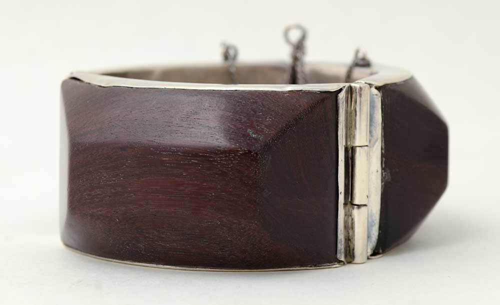 Wonderfully sculptural, original design three panel bracelet. Each wood panel has five facets. It is made of 980 silver, higher quality than sterling. The bracelet has a pin closure; the inside diameter is 2 3/16