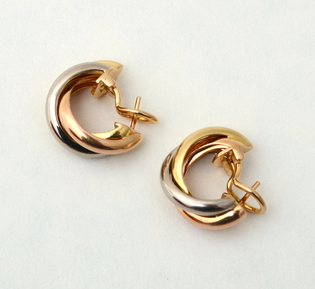 Cartier's trinity design of white, yellow and rose gold is well known the world over. These earrings are easy to wear for any occasion. Measurements are 5/8