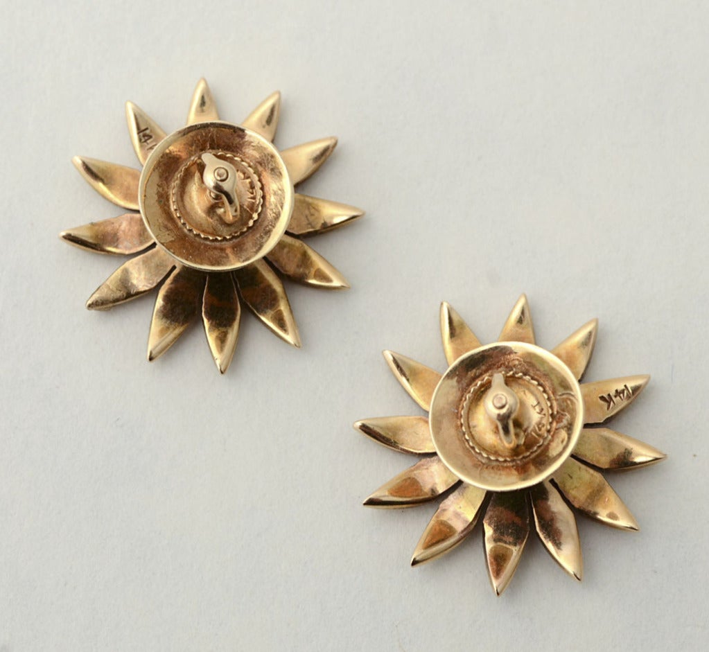 Delicate Flower Earrings in which each petal is encrusted with seed pearls and a diamond in the center to add just the right amount of sparkle. The earrings are nearly an inch in diameter with post backs.