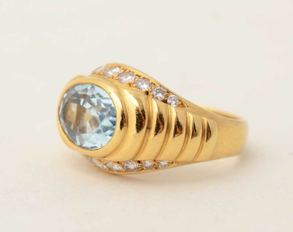 Lovely aquamarine and diamond ring by Bulgari. The central stone weighs 2 1/4 carats and is surrounded by interesting stepped sides. The ring is size 6 1/2 but can easily be sized up or down. Condition is excellent.