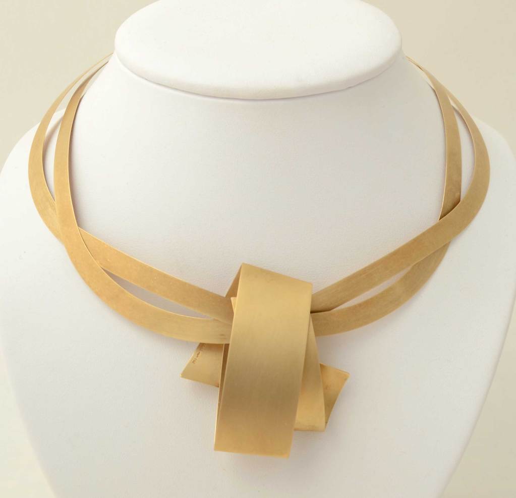 This necklace and earring set by the Modernist German designer, Niessing, is both striking and versatile. The necklace can be worn with the pendant or alone as an intertwined choker. The pendant measures 2 1/8 inches long and 1 13/16 inches wide.