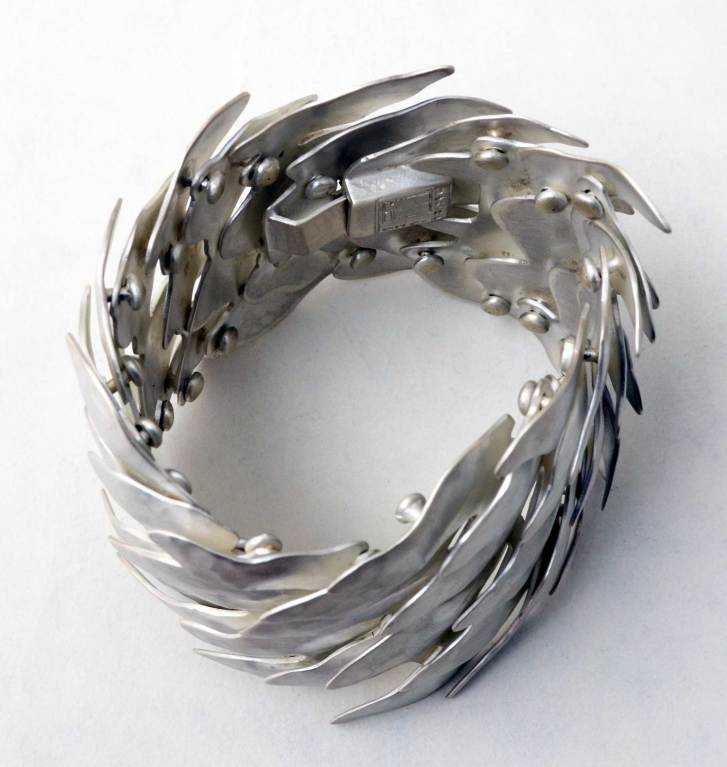 Undulating silver Scales bracelet by Mexican architect turned jeweler, Eduardo Herrera. The numerous overlapping links give the bracelet a surprising fluidity, given its size. It is very comfortable to wear. The bracelet is 2 1/2