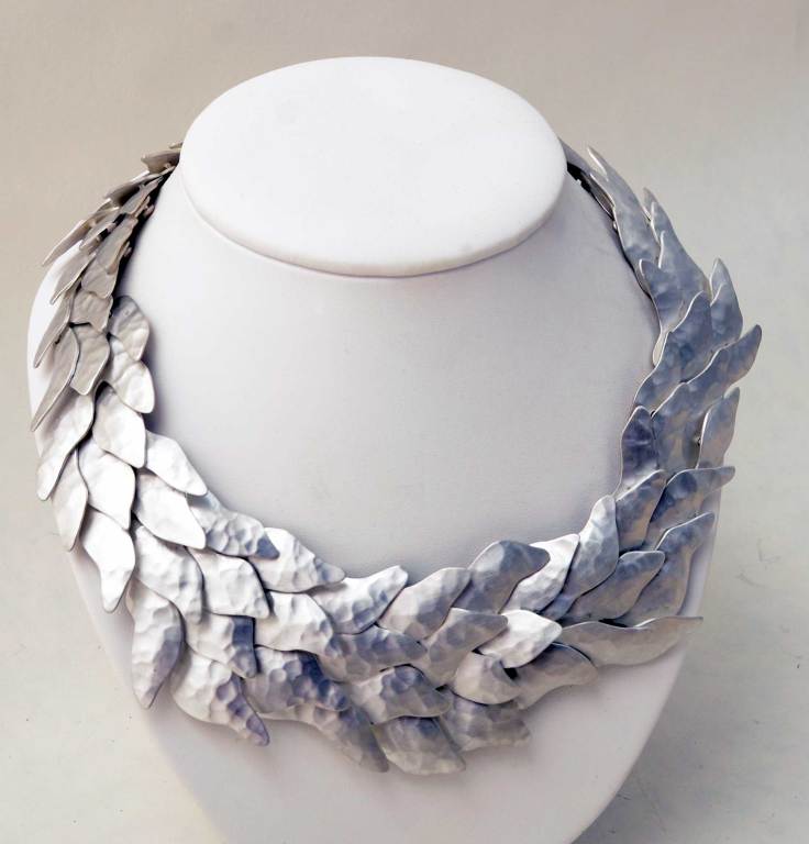 Mexican architect Eduardo Herrera has translated his skills to the art of jewelry making. The necklace is densely articulated, allowing it to move easily on the body. The numerous rivets make the back as beautiful as the front. It has a  matte,