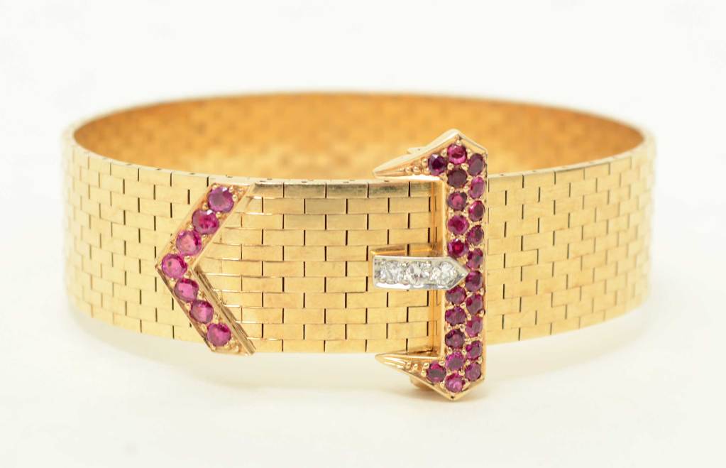 This classic Retro Buckle Bracelet is a bit out of the ordinary because of the combined use of rubies and diamonds. The body of the bracelet is made of tiny rectangles. The size is very adjustable with 8 holes to accommodate virtually all wrists.
