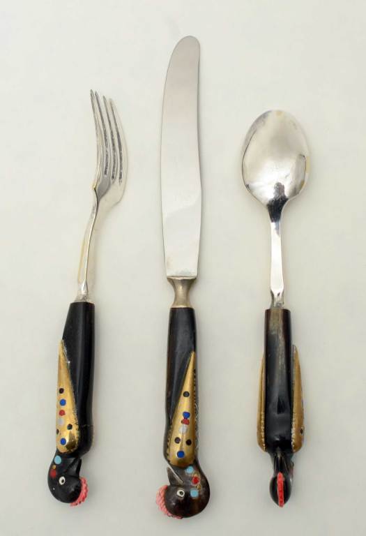 Whimsical luncheon set of Parrot handled flatware. The dark part of each handle appears to be bone embellished with several colors of inlaid resin. The set consists of 6 forks; 6 knives and 6 spoons plus a server. The server is 9 3/4