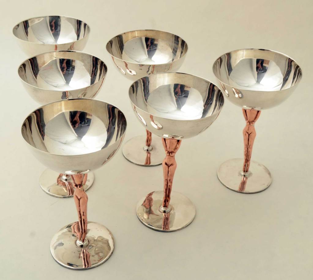 Voluptuous women hold up the bowls of these six unusual champagne coupes or sherbert cups. Thumbnail images indicate how perfectly formed they are in the round. The women are made of copper; the bowls and bases are sterling silver. Needless to say,