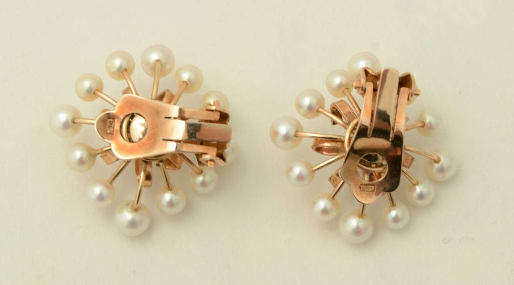 Light and airy pearl earrings with a very 1950's celestial design. Measure 1" in diameter; clip backs.