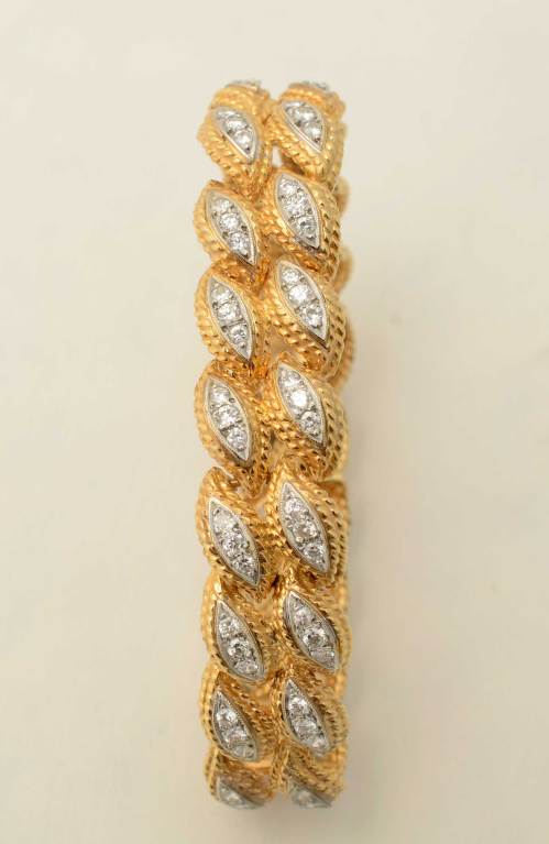 Two rows of navette shaped links are filled with diamonds in this lovely bracelet from the 1960's. It has 3.6 carats of diamonds set in 18 karat gold. Measurements are 6 3/4