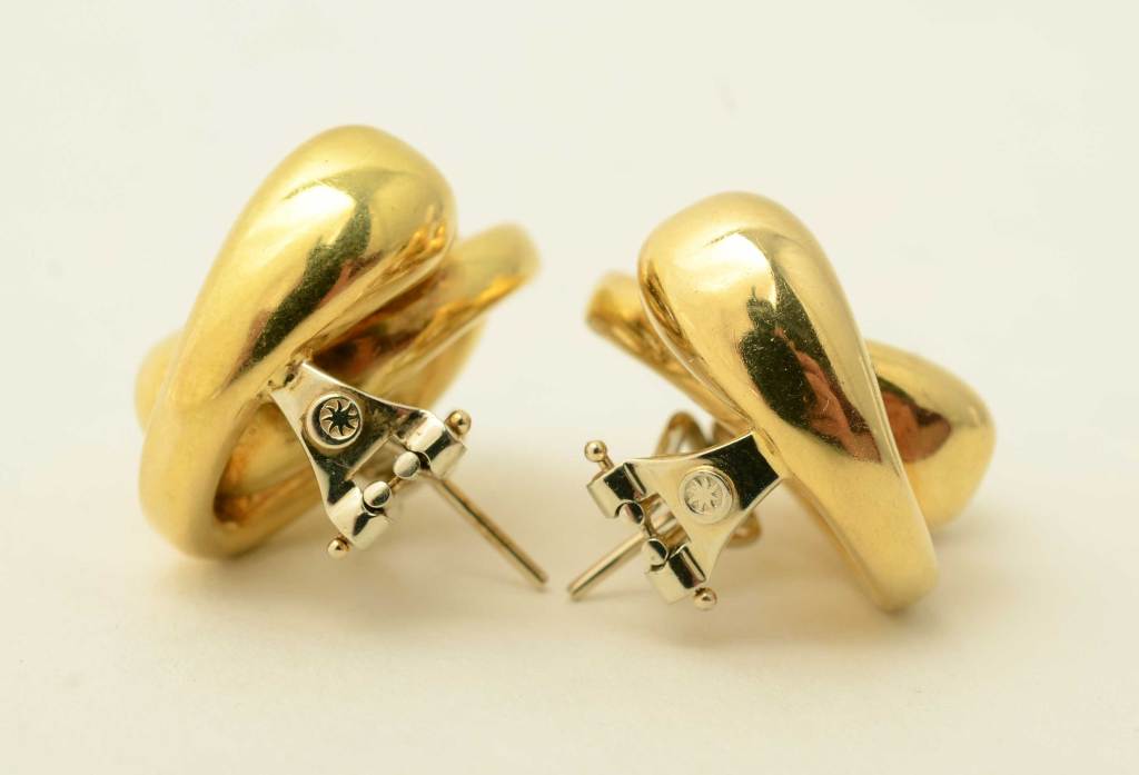 Bold and unusual double U shaped 18 karat gold earrings. Large enough to make a statement yet light enough to be worn very comfortably. Omega backs. Has maker's mark but not one I recognize.