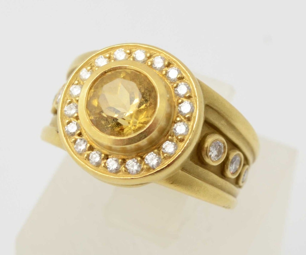 Stylish ring by Barry Kieselstein Cord with a central citrine stone surrounded by diamonds. Graduated size diamonds flank the central area. Dated 1993. Ring is size 7 but can be sized.