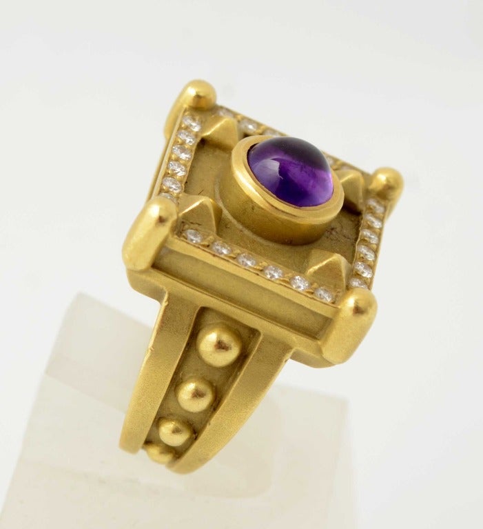 Heavy 18 karat gold ring by Barry Kieselstein Cord with a central  amethyst cabochon stone surrounded by diamonds. Dated 1995; excellent condition. Size 7 can be modified smaller or larger.