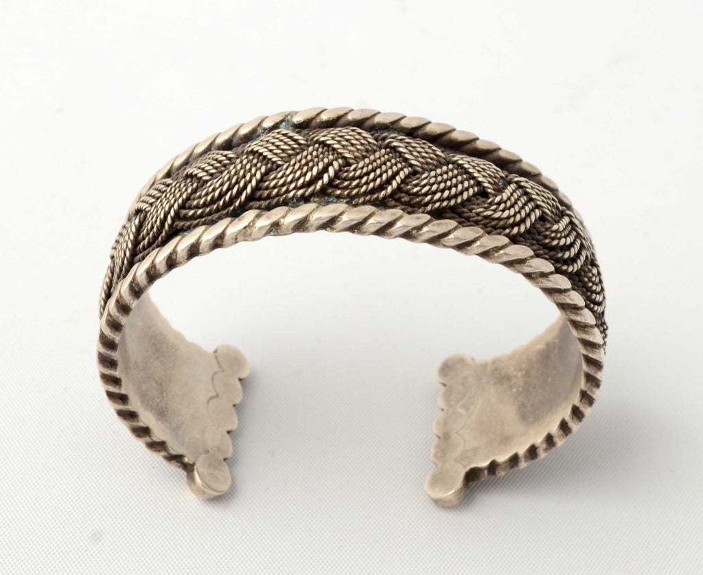 Strong design to this braided cuff bracelet by silver master, Hector Aguilar. The bracelet is 940 silver, higher quality than the sterling standard. Each end has a series of five circles. Hallmark dates between 1948 and 1962. The cuff is 7/8