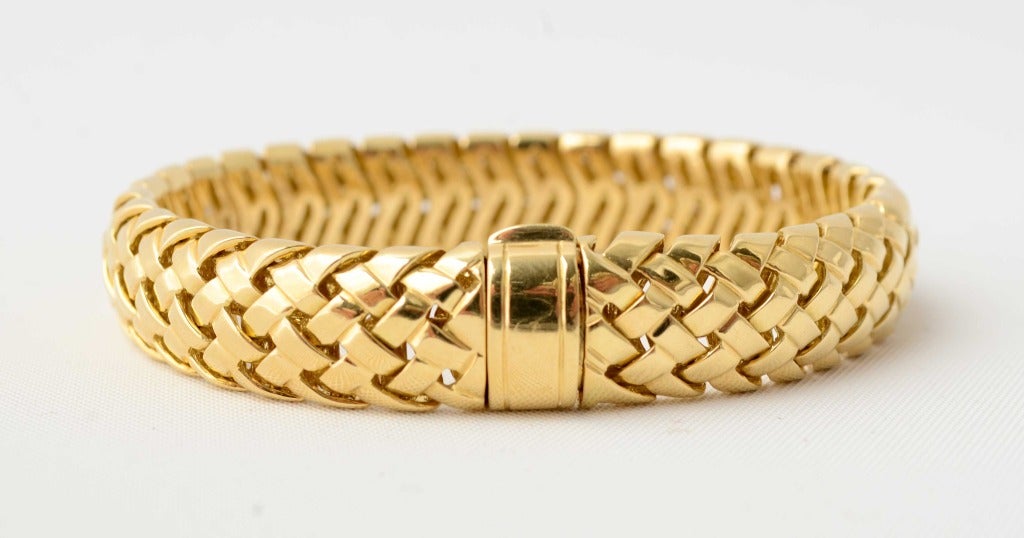 Braided 18 karat gold bracelet by Tiffany. It is the ideal bracelet to wear anywhere at any time. It looks great either on its own or grouped with other bracelets. It is 1/2