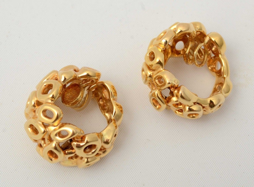 These huge 18 karat gold hoop earrings by Paloma Picasso are truly a work of art. They are a combination of open squares; circles and navettes, all irregularly set. Measurements are 1 1/2