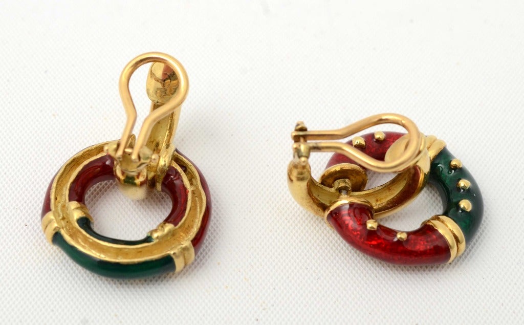 Red and green enamel  circles  are suspended from gold hoops in these colorful earrings. Clip backs can be converted to posts. Nicely made with gold details throughout the enamel.