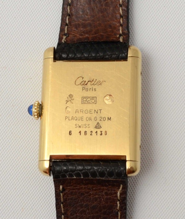 Le Must de Cartier lady's gilt Tank wristwatch with an unusual dial of the Trinity stripe for which they are well known in jewelry. The case is gold vermeil over sterling silver. It dates to the 1980s and is has a manual-wind movement. Crown is