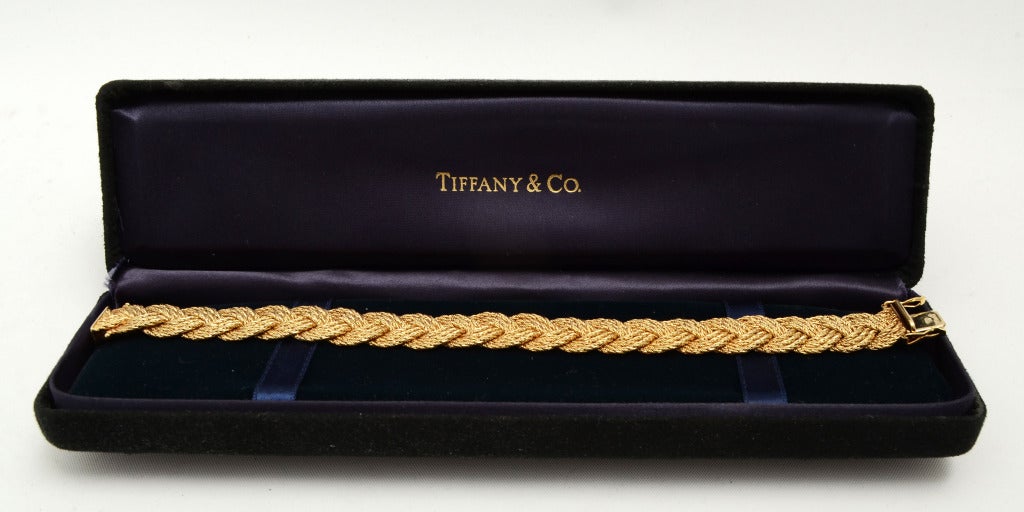 This woven gold bracelet by Tiffany is made of strands of gold that are  braided. Measures 7 1/2