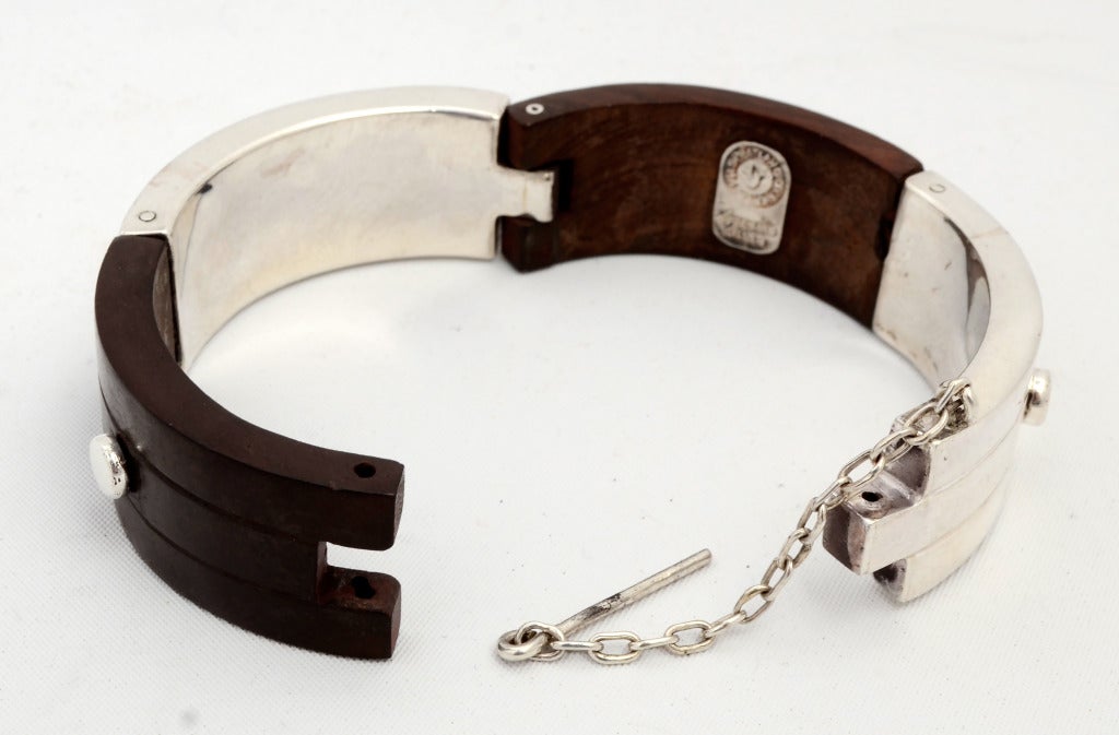 Rarely seen, highly wearable bracelet by silver master, William Spratling. It is made of of four segments of sterling silver and ebony wood. The inside diameter is 2 1/2