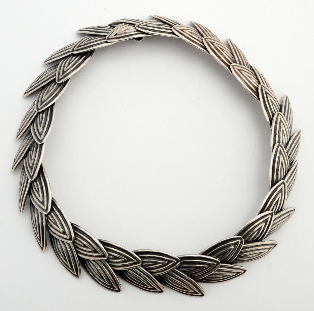 Beautifully made, heavy sterling silver necklace by Los Castillo. Navette shaped links are joined to create pairs of abstracted leaves. Each has concentric rows of oxidized lines. The difference in depth as well as color contributes to the striking
