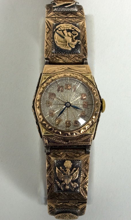 Handmade sterling silver and gold watch that belonged to Roy Rogers, King of the Cowboys. Roy purchased this watch on a fishing trip to Mexico. Emblems in gold depict the insignias of the US and Mexico. Rubies on the buckle and keeper. Metals are in