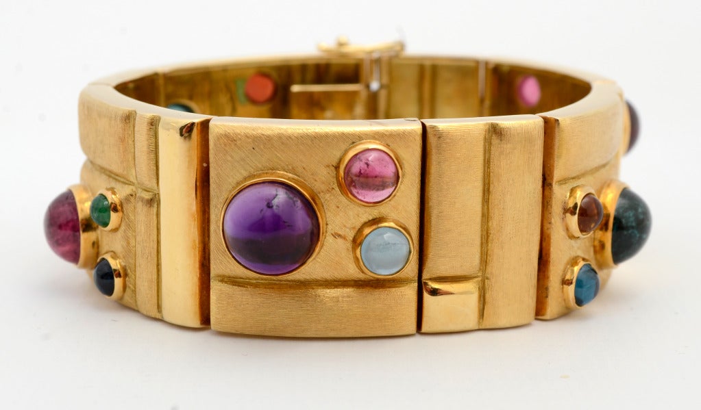Stunning and festive gold bracelet by Brazilian designer, Haroldo Burle Marx. Marx is known for both the design of his jewelry and the fine quality of his stones. Trios of cabochon stones are placed throughout this bracelet of varying size squares