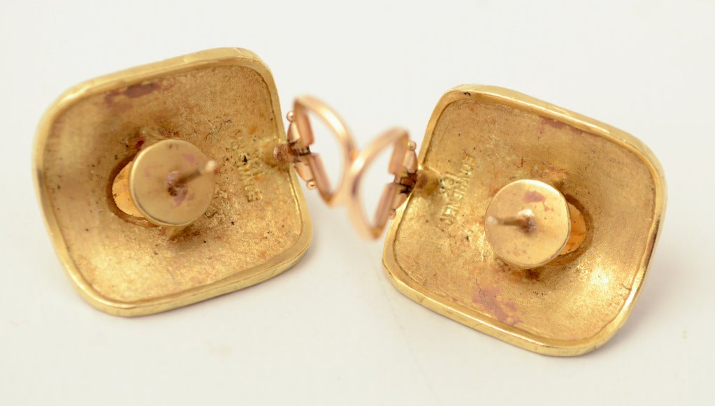 Wonderfully textured gold earrings by New York designer, Ed Wiener. The richly colored citrines are surrounded by a fine granulated pattern. The rectangular earring is convex in form. Measurements are 15/16