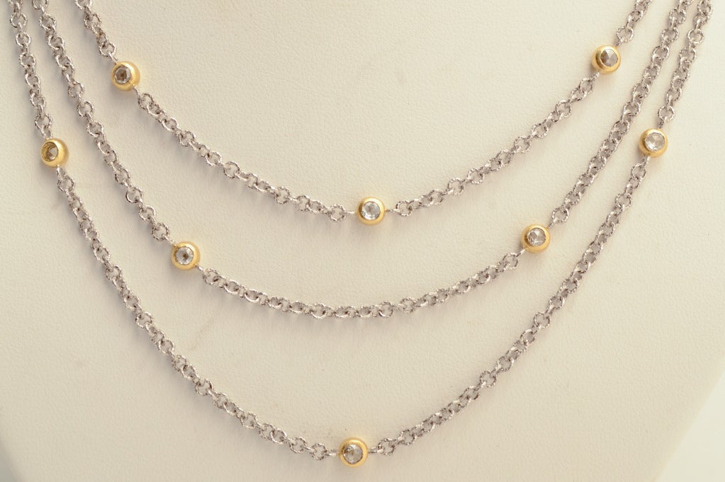 This three chain white gold and diamond necklace by Buccellati is known as their Marissa piece. It consists of three graduated length chains that are set with 14 diamonds in yellow gold. The shortest chain is 16