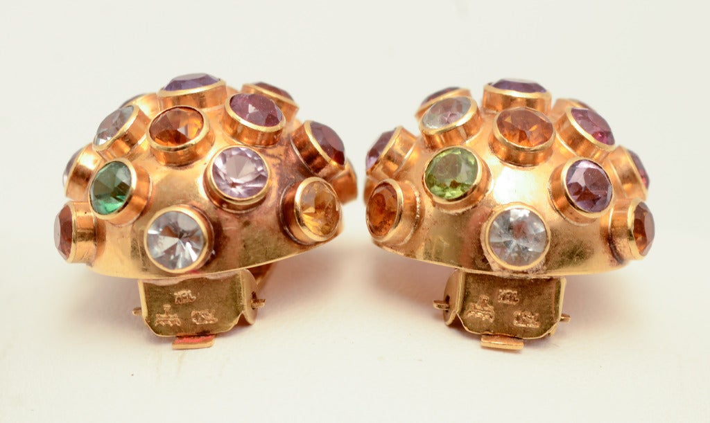 Eighteen  karat domed earrings set with a wonderfully colorful array of semi precious stones. The stones include garnet; peridot; citrine; topaz and amethyst. Clip backs; measure 11/16