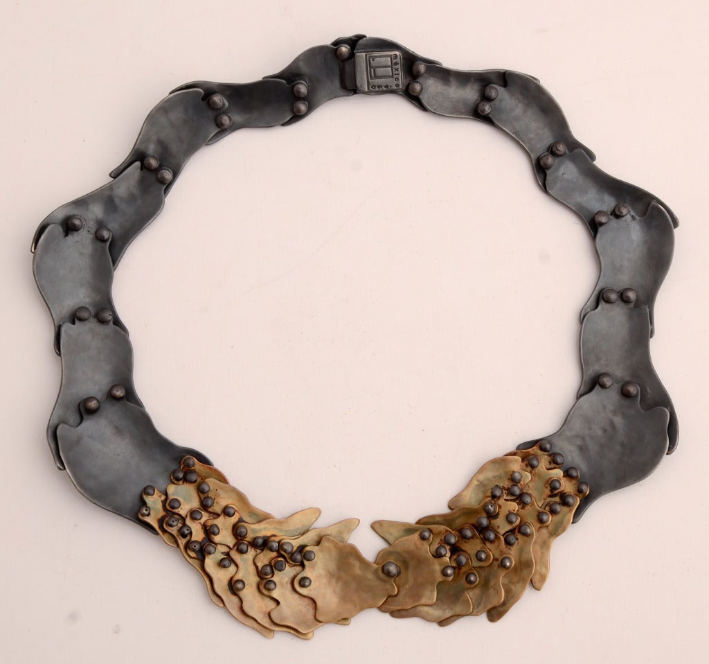 Dramatic and unusual necklace by Mexican architect turned jeweler, Eduardo Herrera. His architecture background is evident in the construction of this necklace in which the back is as beautiful as the front (see next to last thumbnail photo).

It