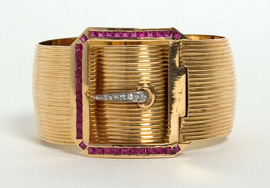 Richly colored, 18 karat rose gold Retro Buckle Bracelet. Buckle is surrounded with rubies and diamonds in the center. Widest part of the bracelet is 1 1/2