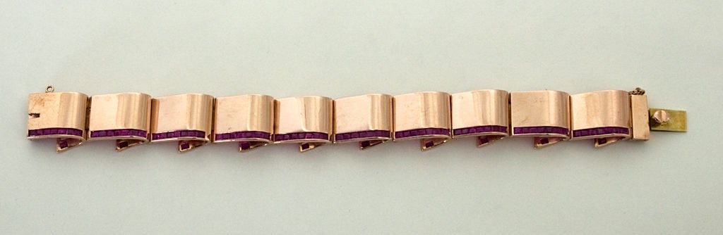 Understated and elegant Retro bracelet in 14 karat rose gold. Undulating links truly have the effect of folded ribbon with rubies on the underside as well as the front. Measures 7 1/4