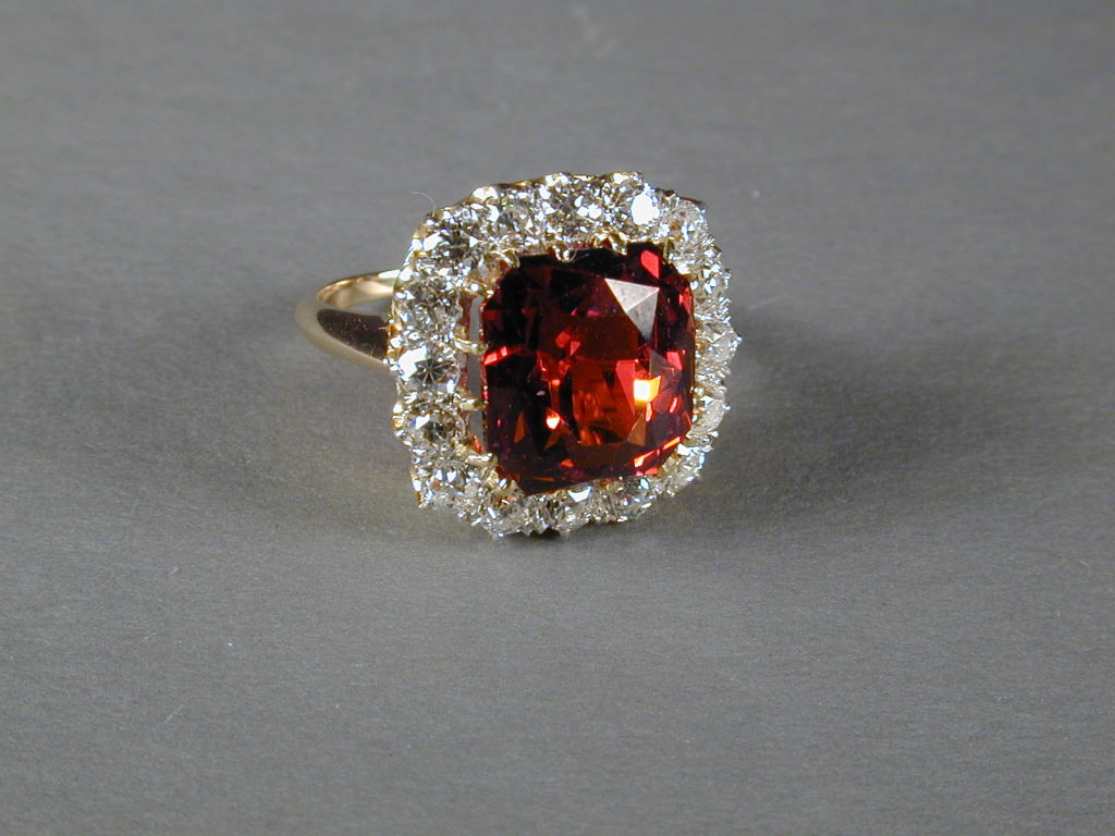 TIFFANY & CO. Fine Spessartite Garnet and  Diamond Ring mounted  as a cushioned cluster in 14kt Gold.