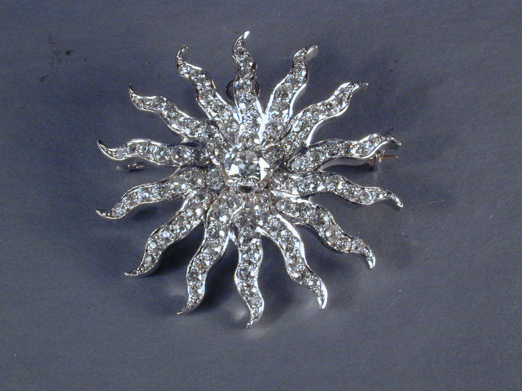 An American classic diamond sunburst pin. Often these were worn in pairs or more, scattered around the neckline and even worn in the hair.This example is particularly fine