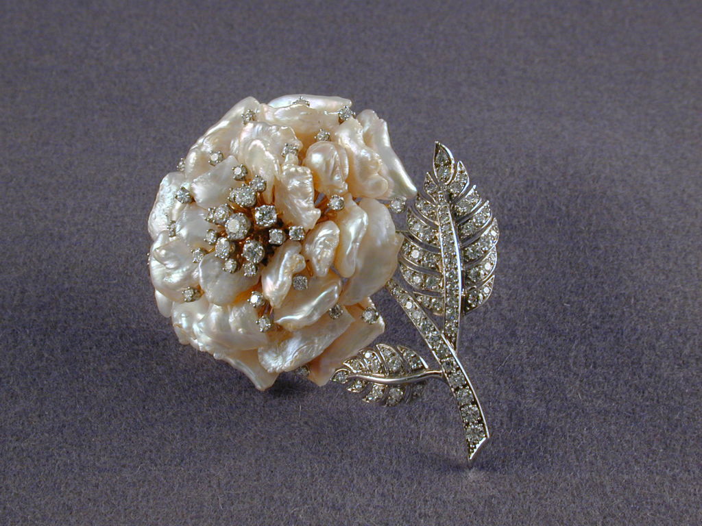 RUSER Fresh Water Pearl blossom set with diamond pistils attached to  diamond set stem and leaves.